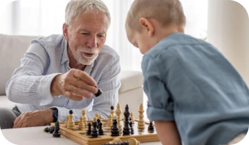 Grandfather playing chess with his grandson, staying mentally sharp with healthy memory and focus
